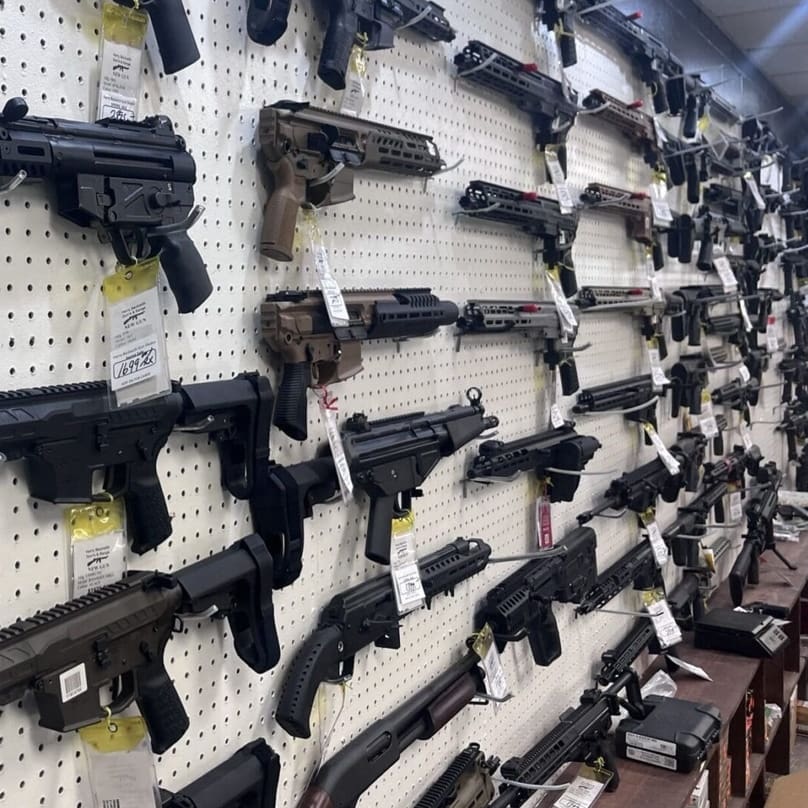 TGK licensed FFL firearms showroom with display cases and expert staff